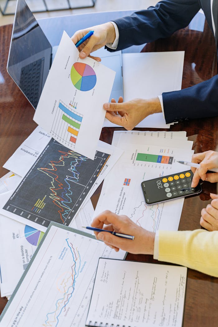 Mastering the First Impression: Your intriguing post title goes here Business professionals analyzing financial charts and graphs during a meeting.